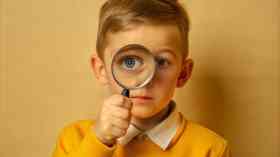 Young boy with magnifying glass