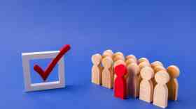 Picture of wooden people next to tick box.