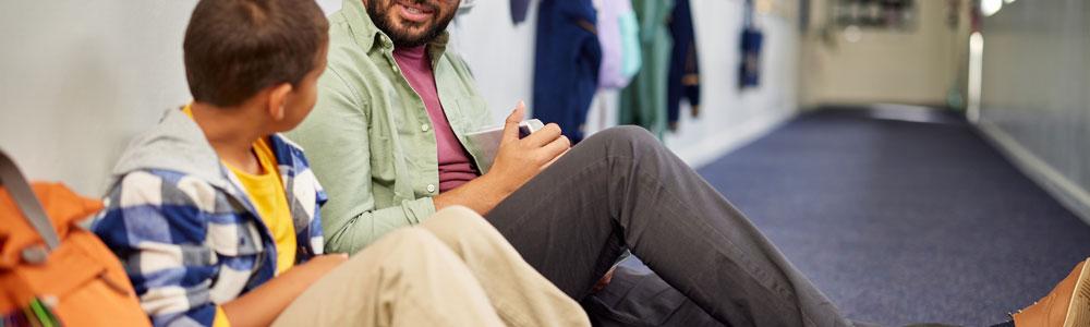 Teacher sitting on floor with child