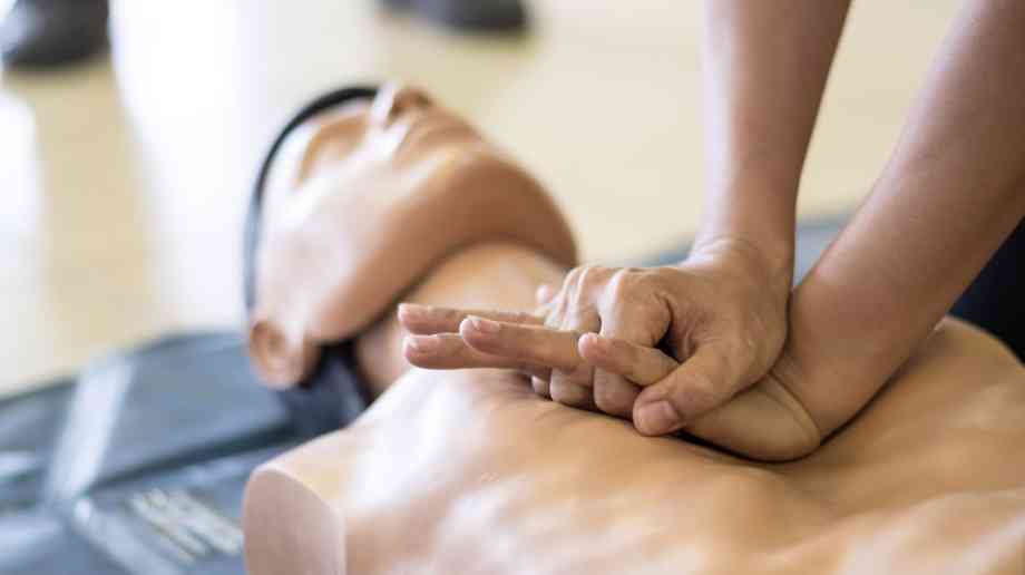 Practicing chest compressions using a dummy.