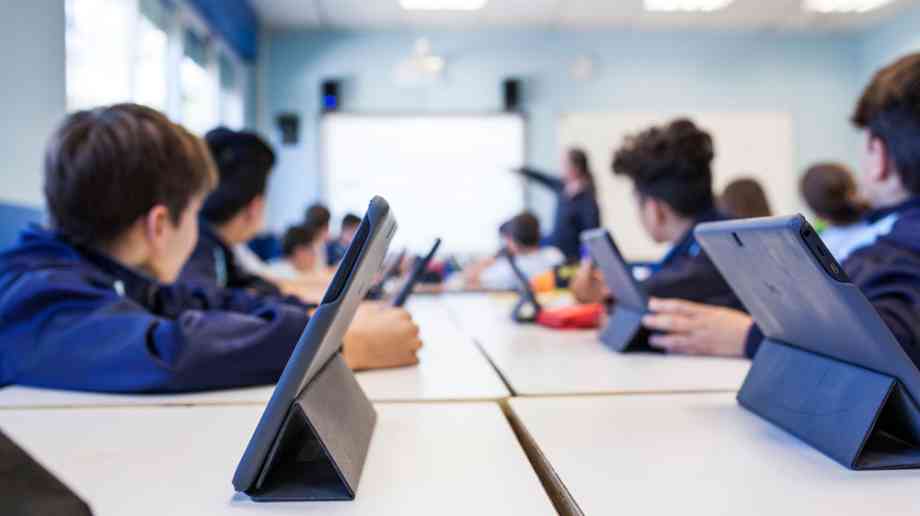 School pupils using ipads in a lesson.