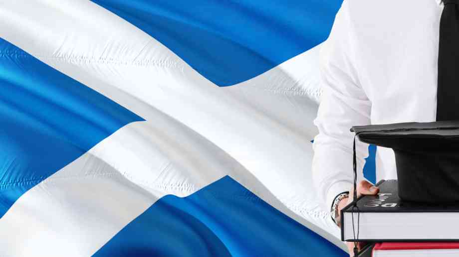 University student in front of Scottish flag.