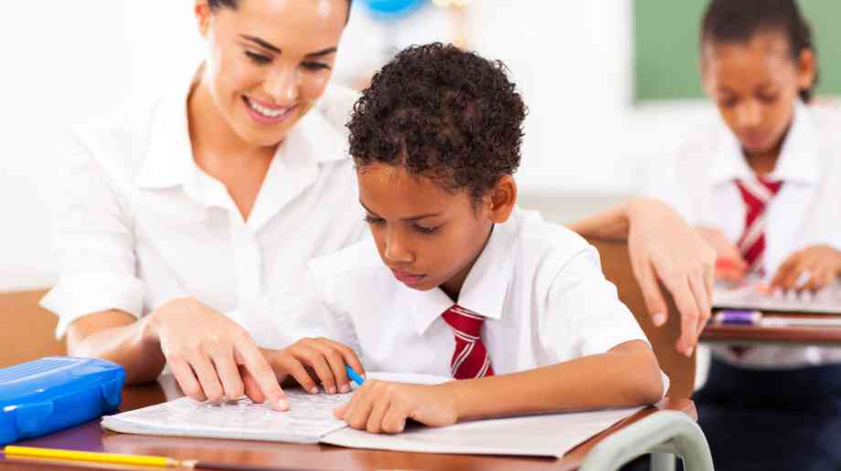 Child getting help from teacher