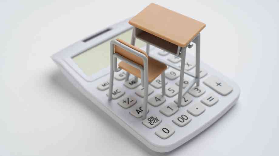 School desk on top of calculator.