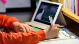 Child doing homework on ipad